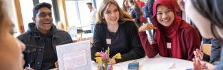 Students gather at a table