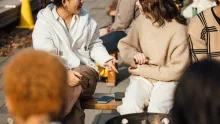 students sitting by a fire